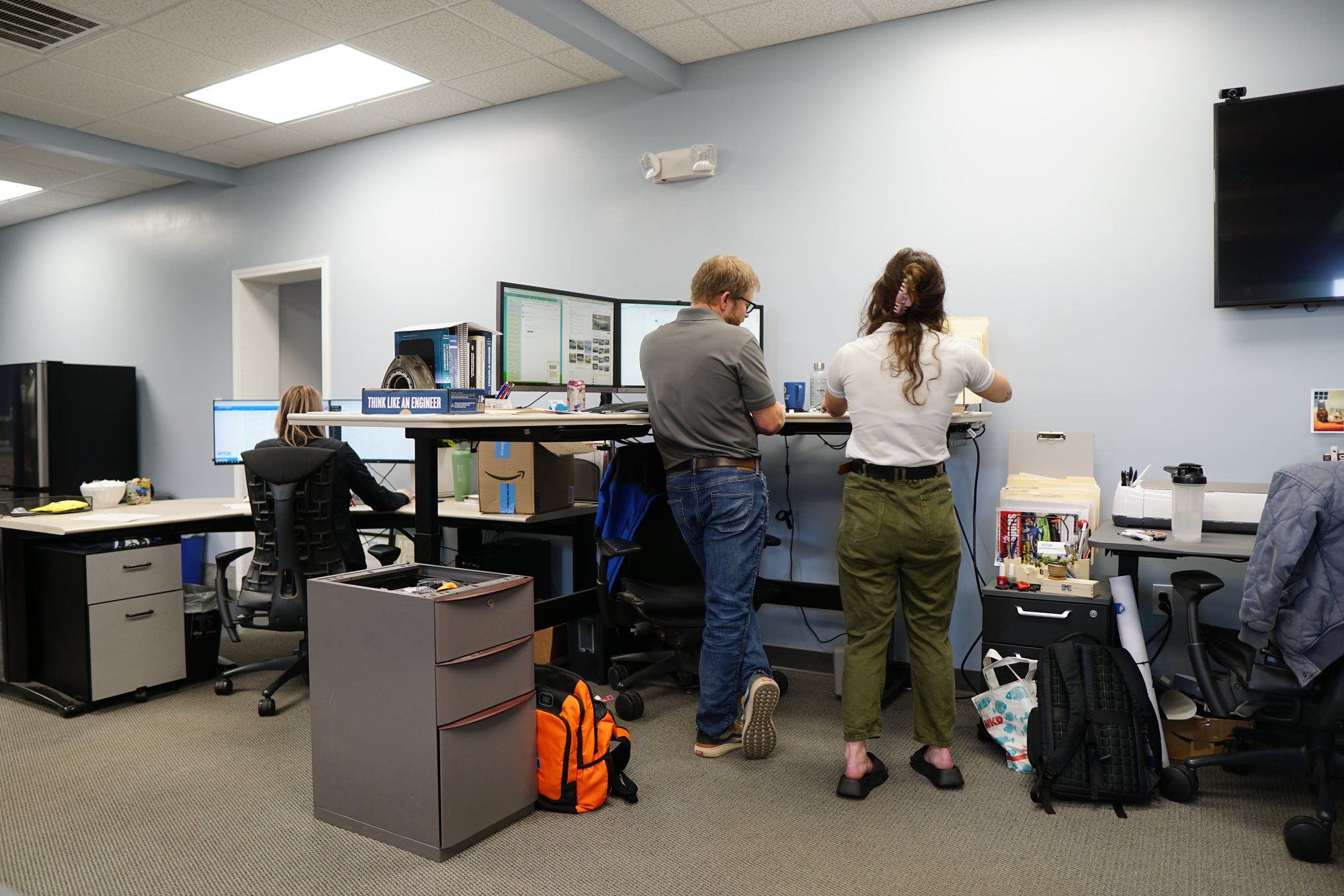 APTUS team members working together in the bright design office