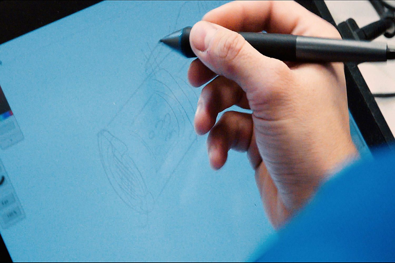 An APTUS designer sketching a product concept on a drawing tablet