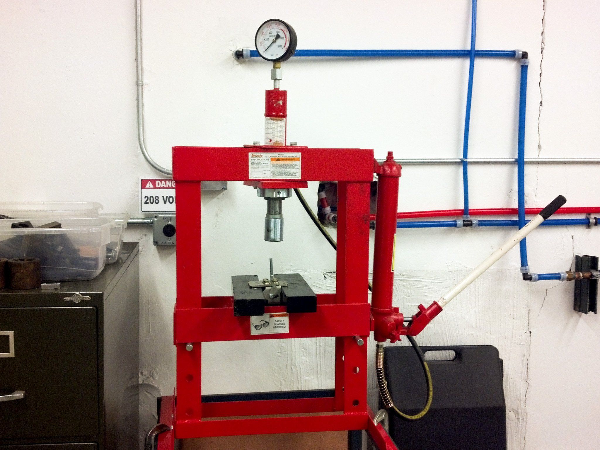 The hydraulic press used to test the bracket in the APTUS shop