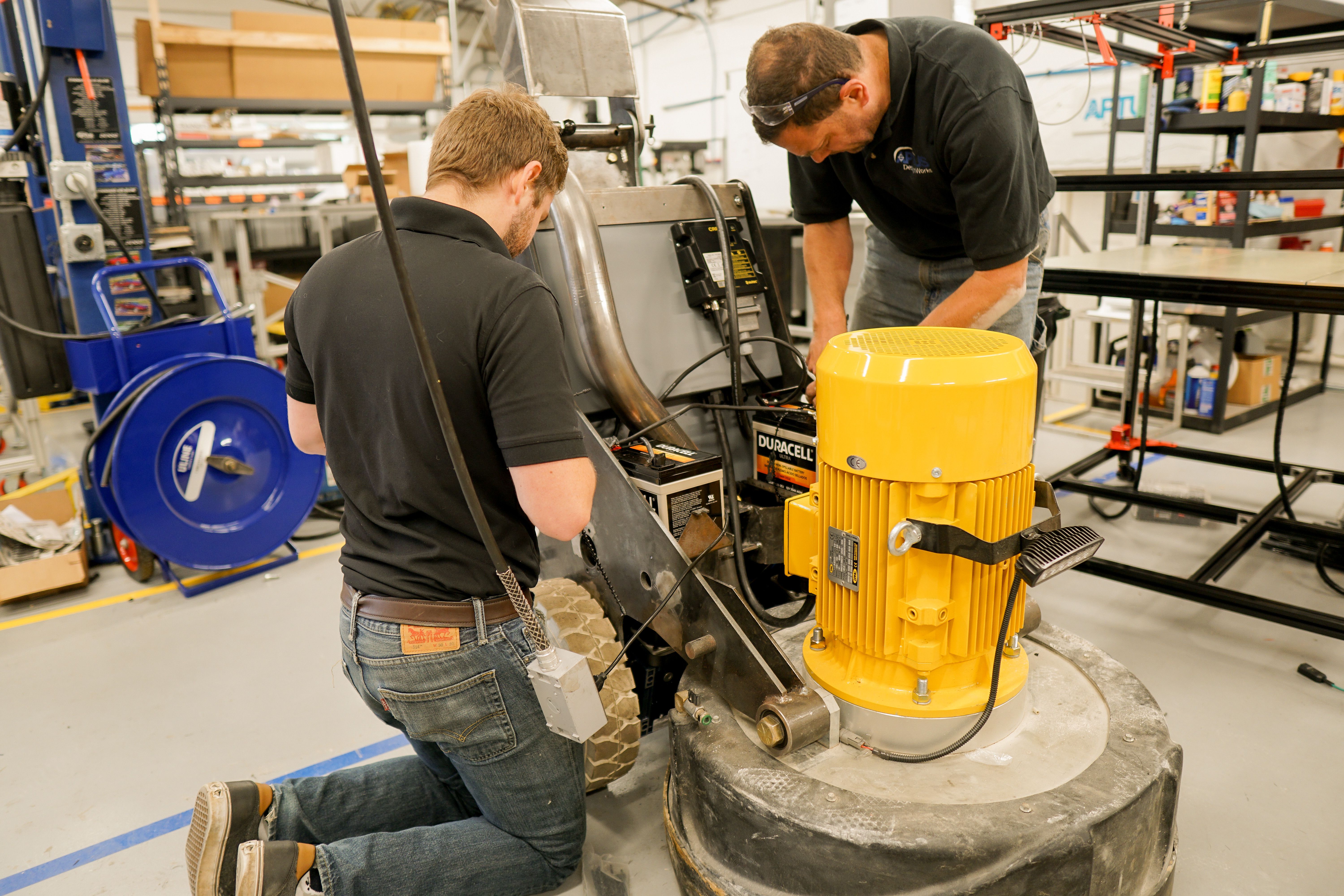 Engineers working on an 8KR grinder prototype in the APTUS shop