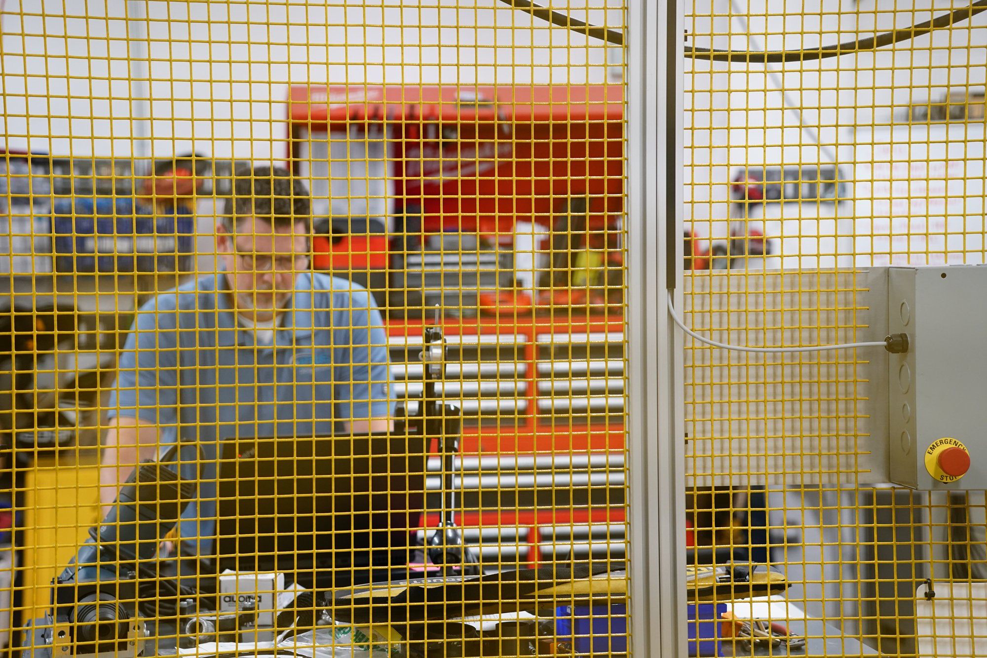 An APTUS engineer working inside a guarded automation cell
