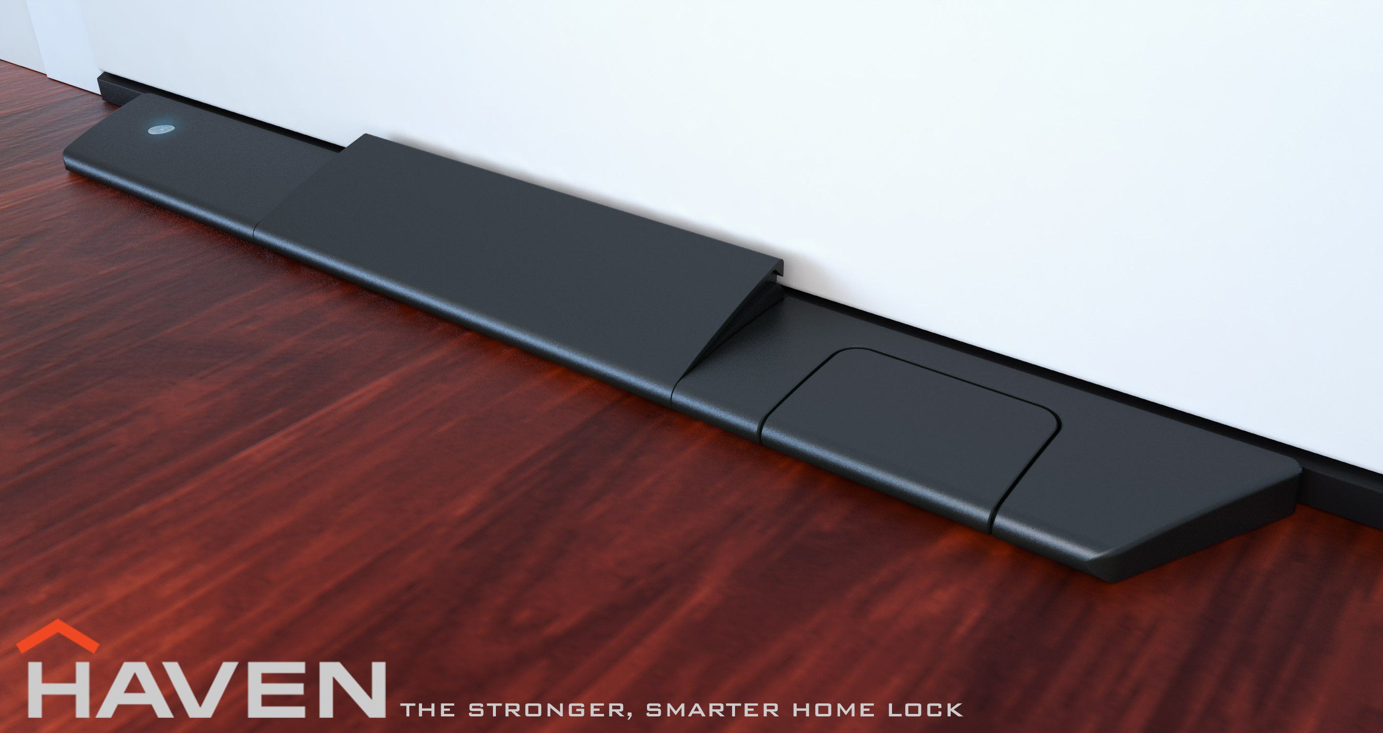 The HAVEN lock installed at the base of a door on a wood floor