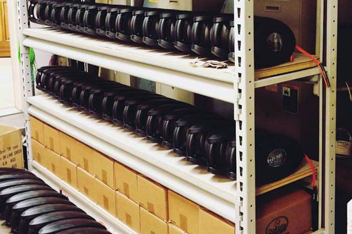 Production housings stacked on shelves above boxed stock