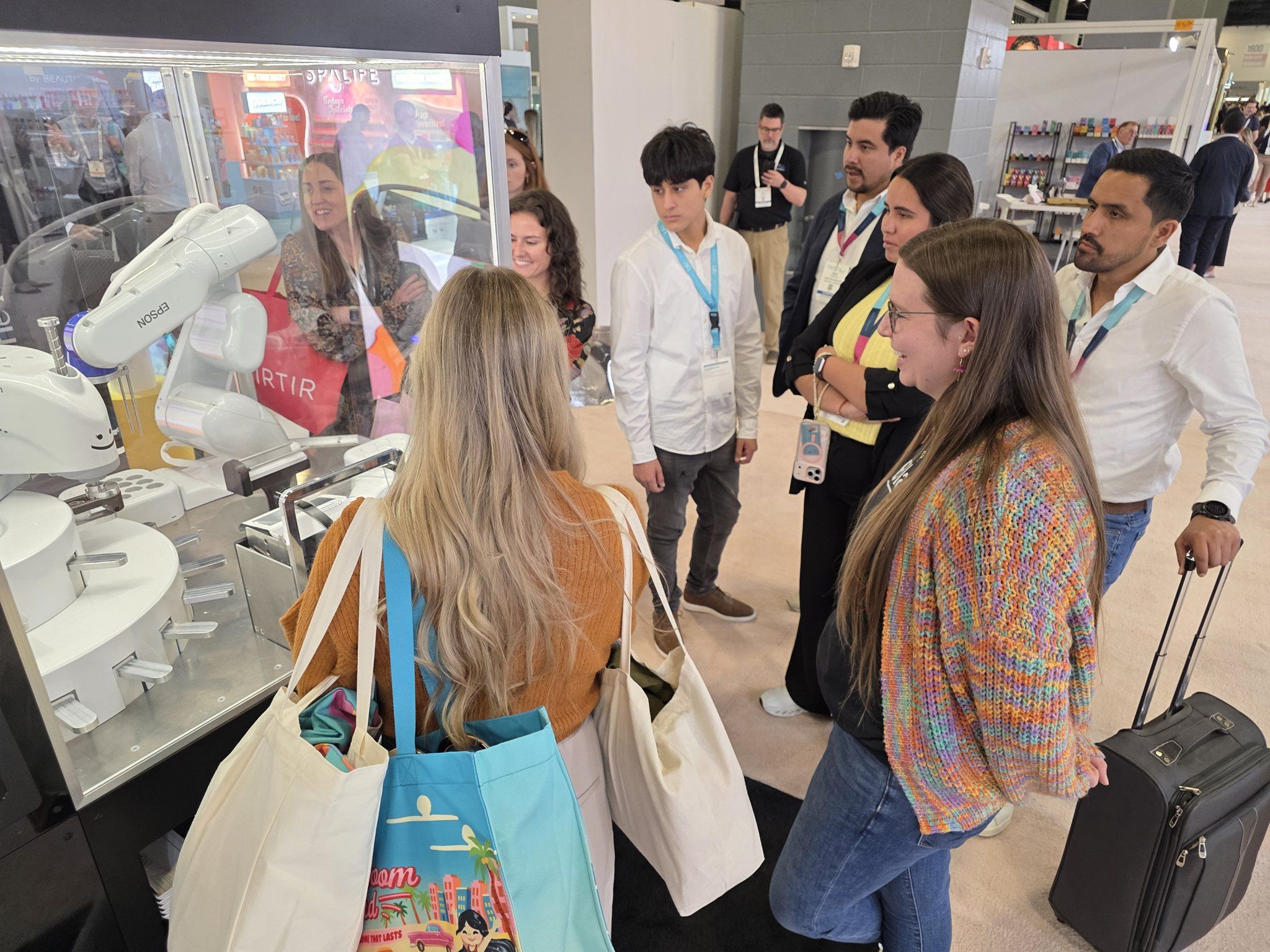 Visitors gathered around Vivi's case watching a shade being mixed at the booth